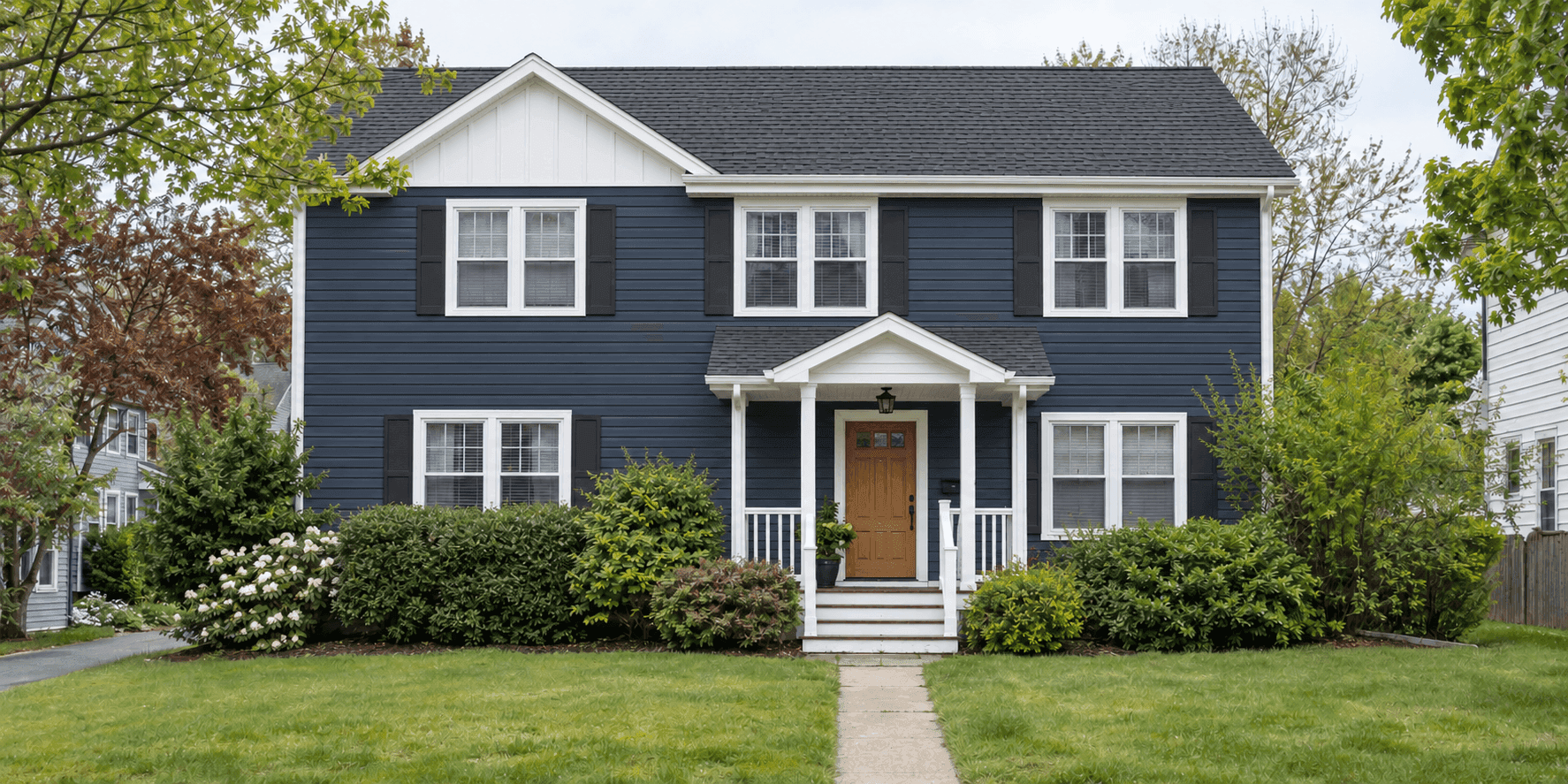 AI-generated demo: the same house with navy siding, a new charcoal roof, refreshed white trim and an oak front door after renovation