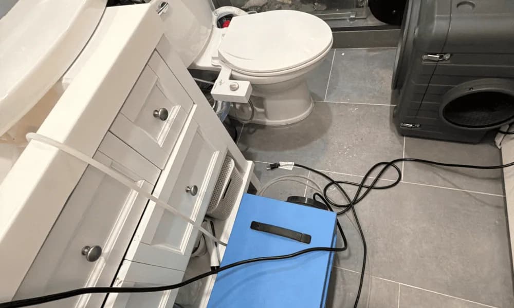 Drying equipment and cables positioned on a bathroom floor
