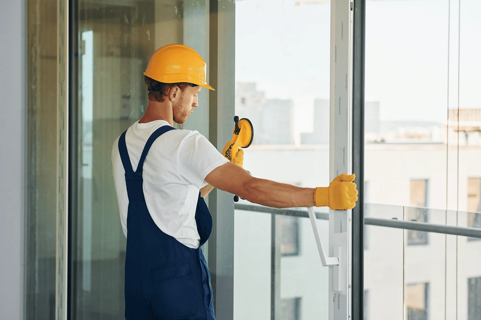 Installer checking a tall window frame with a spirit level