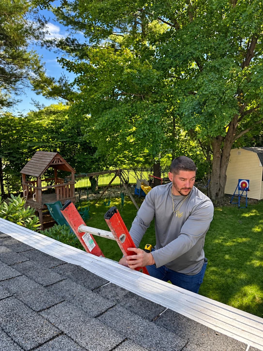 A Vesta team member inspecting the roof and gutter line on a ladder in New Jersey