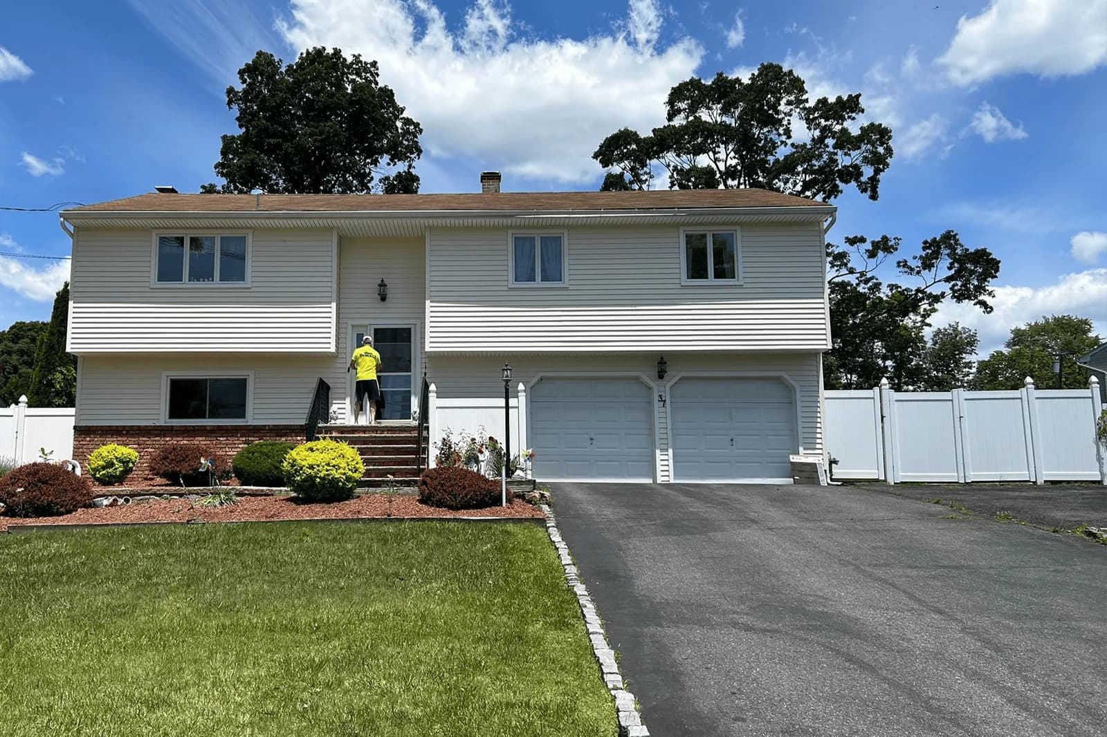 Completed Vesta residential siding project on a white split-level home