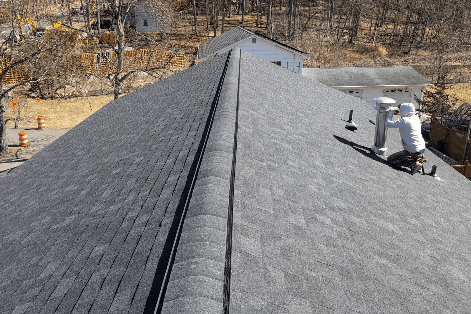 A Vesta roofing team member working beside a chimney on a New Jersey home