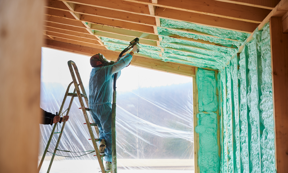 Installing fiberglass insulation in a residential attic during home energy upgrade in New Jersey