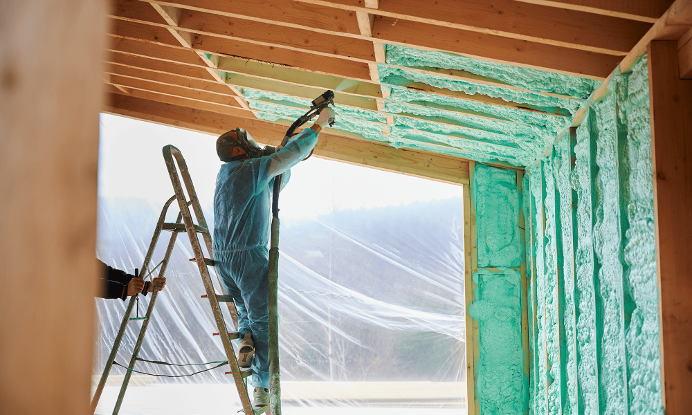 Installing fiberglass insulation in a residential attic during home energy upgrade in New Jersey