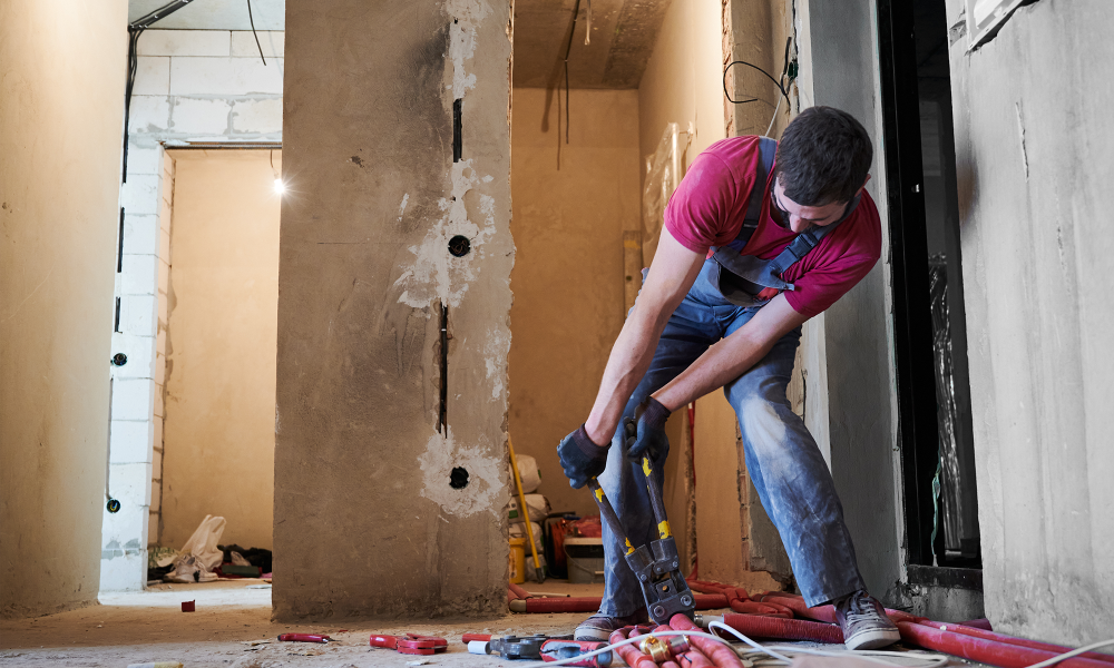 Technician drying water-damaged walls with professional restoration equipment in a New Jersey home