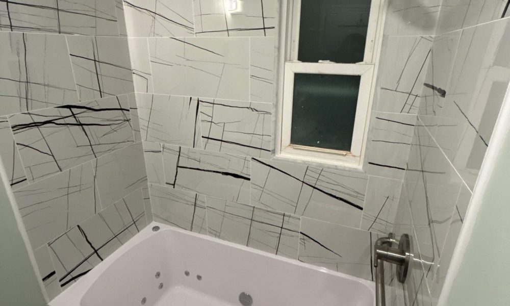 Modern bathroom remodeling project in New Jersey featuring tile shower vanity and lighting by Vesta Remodeling