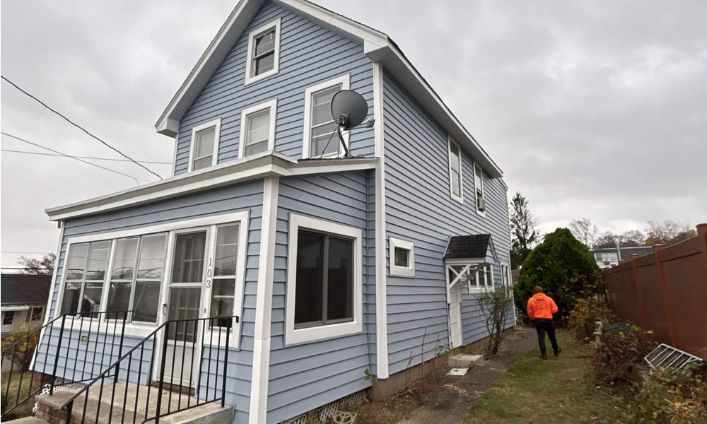 Exterior home remodeling project in New Jersey featuring new siding windows and front porch renovation by Vesta Remodeling