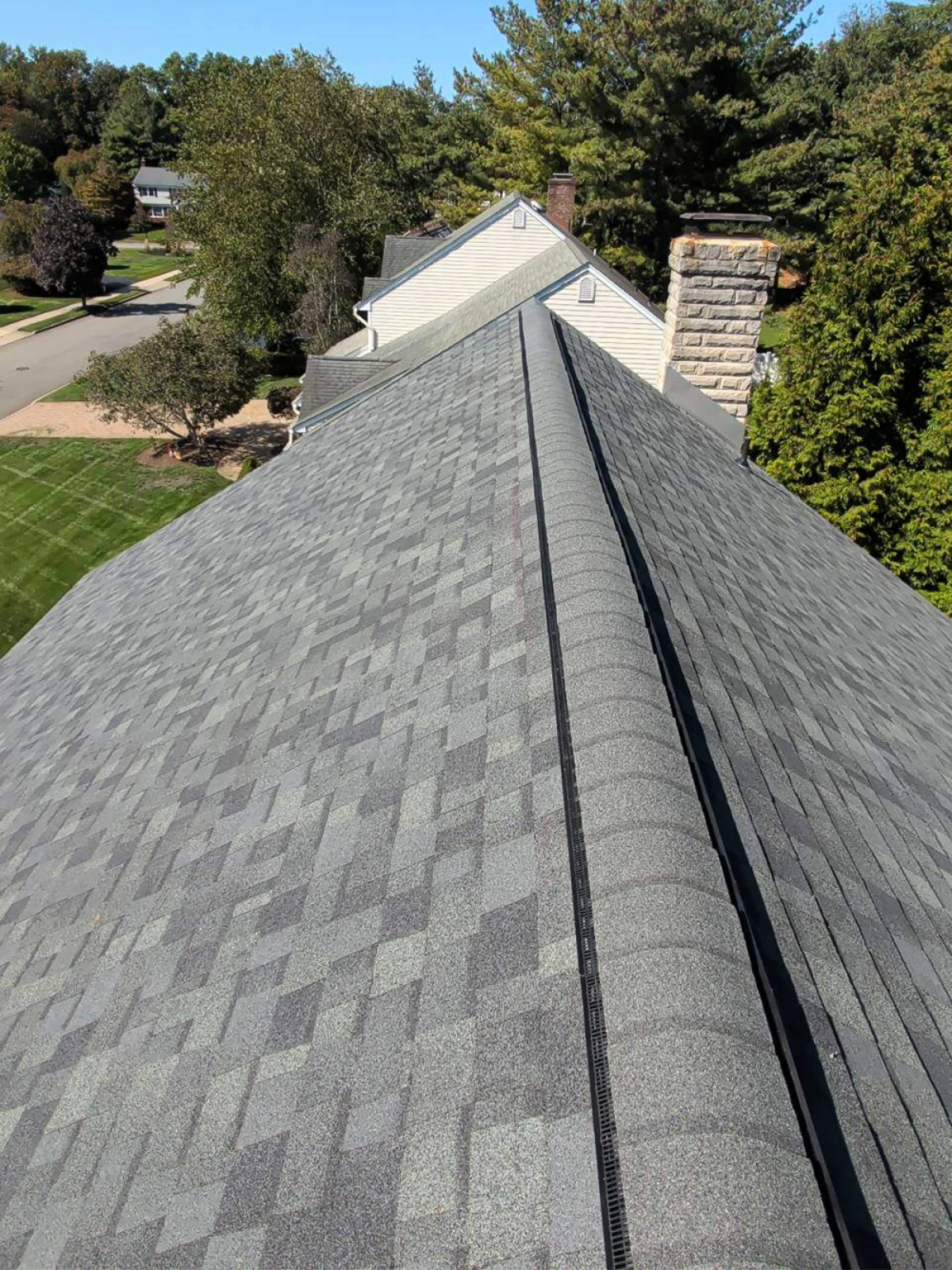 Completed residential asphalt shingle roof with ridge vent installation in New Jersey by Vesta Remodeling