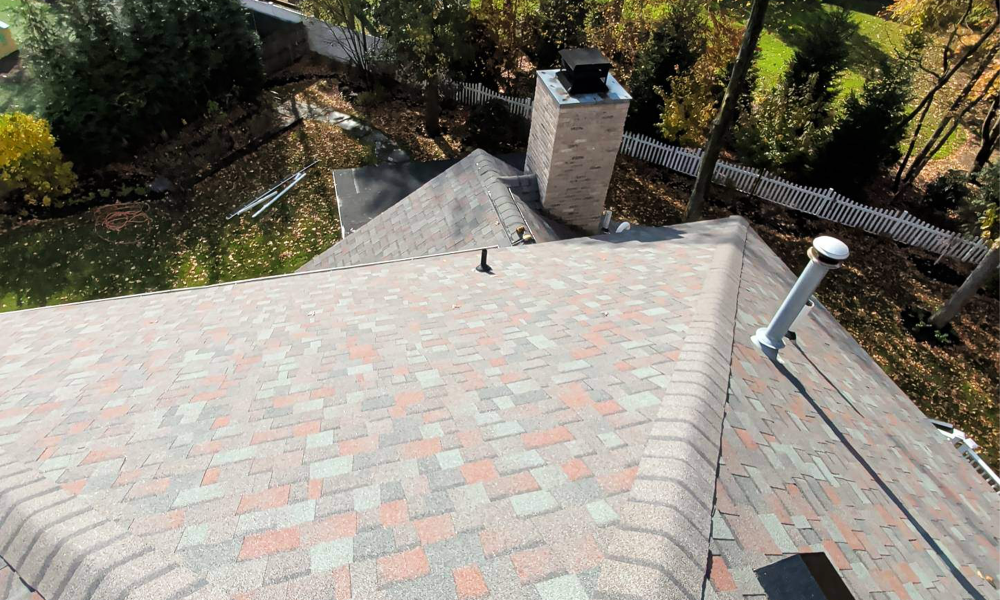 Residential asphalt shingle roof installation around chimney in New Jersey by Vesta Remodeling