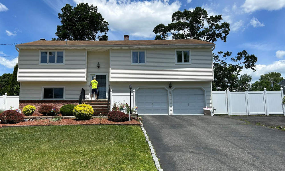 Exterior home renovation in New Jersey featuring new siding replacement and driveway improvement by Vesta Remodeling